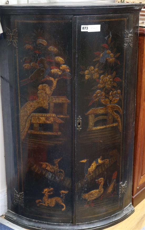 A George III black japanned bowfront hanging corner cupboard, W.62cm